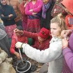 Simone Bodmer-Turner demonstrating candle making to women